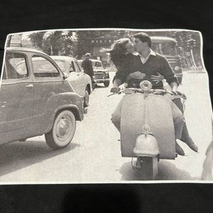 Couple on Vespa kissing